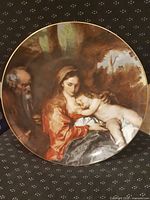 Full view of decorative plate front showing artwork and gold rim