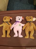 Group shot of all three Ty bears: two tan, one pink