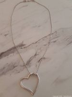 Full view of necklace showing chain and heart pendant