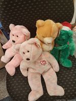 Group shot of four Ty Beanie Baby bears on chair