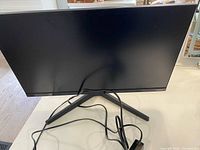 Front view of 24-inch Samsung monitor on Y-stand with power cord