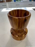 Front view of cedar vessel showing hourglass form and glossy finish