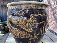 Side view showing high-relief dragon and glaze contrast