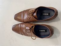 Top view of both cognac brown cap-toe dress shoes