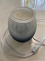 Full view of wax warmer showing ombre crackle glass body, melt dish and cord