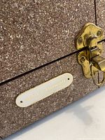 Close-up of case exterior showing fabric finish and brass latch