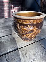 Oblique view showing dragon relief and rim border