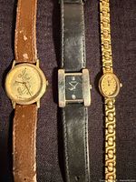 Front view of all three watches showing dials and straps
