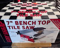 Retail box front showing product name and image of tile saw