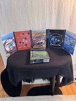 Five open DVD cases showing discs and artwork plus outer slipcase