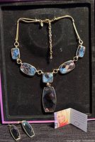 Necklace with earrings in presentation box, Suzanne Sommers info card visible