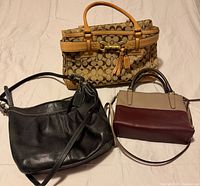 Group view of all three Coach handbags