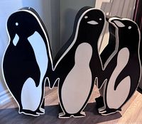 front view showing three connected penguin figures and painted surfaces