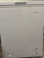 Front view of white Frigidaire chest freezer with brand logo and control dial