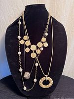 All three gold tone necklaces displayed on bust