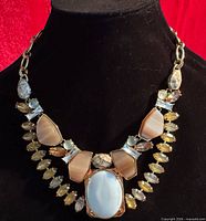 Necklace on bust showing overall design and stone arrangement