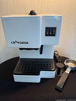 Front view of Gran Gaggia espresso machine with portafilter and scoop-tamper on side