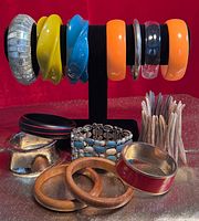 Lot overview showing all bangles and bracelets on stand and table