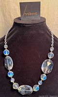 Full view of necklace on display bust showing bead arrangement and Ivana Couture tag