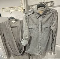 Both garments hanging: striped Michael Kors shirt and grey James Perse blouse