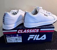Side profile of both shoes on Fila Classics box showing size label