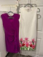 Front view of both dresses hanging