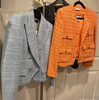 Three jackets hanging: Zara blue tweed, Mango orange tweed, J.Crew grey wool