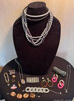 Full lot on display bust showing necklaces, bracelets, rings, earrings, brooch