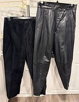 Both pairs of pants hung side by side showing materials and styles