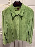 Front view of green suede shacket on hanger