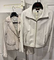 Front view of both jackets on hangers