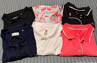 Six polos laid out showing colors and styles