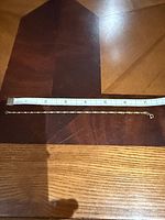 Full view of bracelet next to ruler showing length