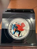 Colourized 2013 $20 Superman silver coin mounted in black acrylic stand