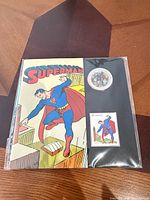 Front view of sealed Superman coin and stamp set