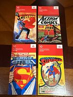 Front view of four Superman stamp booklets showing comic cover artwork