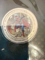 Colorized 50-cent Superman silver coin in capsule