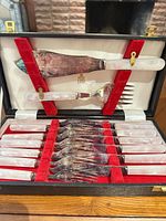 Open case showing all utensils and mother-of-pearl handles