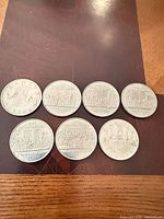 Seven Canadian 1-dollar coins, reverse sides visible