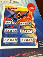 overview of uncut press sheet showing Superman artwork and six souvenir sheets