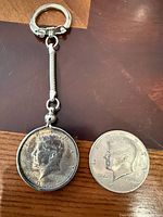Keychain assembly with 1964 coin next to loose 1971 coin