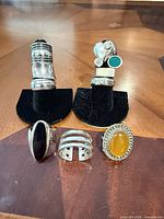 All ten sterling silver rings arranged on stands and tabletop