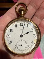 Front view showing dial, hands, and sub-seconds