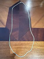 Full view of 30-inch sterling silver herringbone necklace laid flat