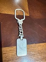 Front view showing braided chain, clasp, engraved tag
