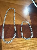 Necklace and bracelet laid flat showing full length and style