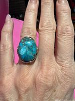 Front view showing turquoise cabochon on finger