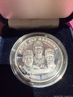 Obverse of medallion showing player portraits, text, edition number in capsule