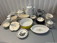 Group shot of all porcelain and ceramic pieces on table