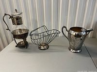 All three silver-plated serving pieces side by side
